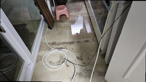 오정구 누수탐지 천장 얼룩과 베란다 바닥의 누수 흔적을 비교하는 모습